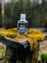 Load image into Gallery viewer, Boy Butter Clear Water Based Personal Lubricant Model shot on a tree stump