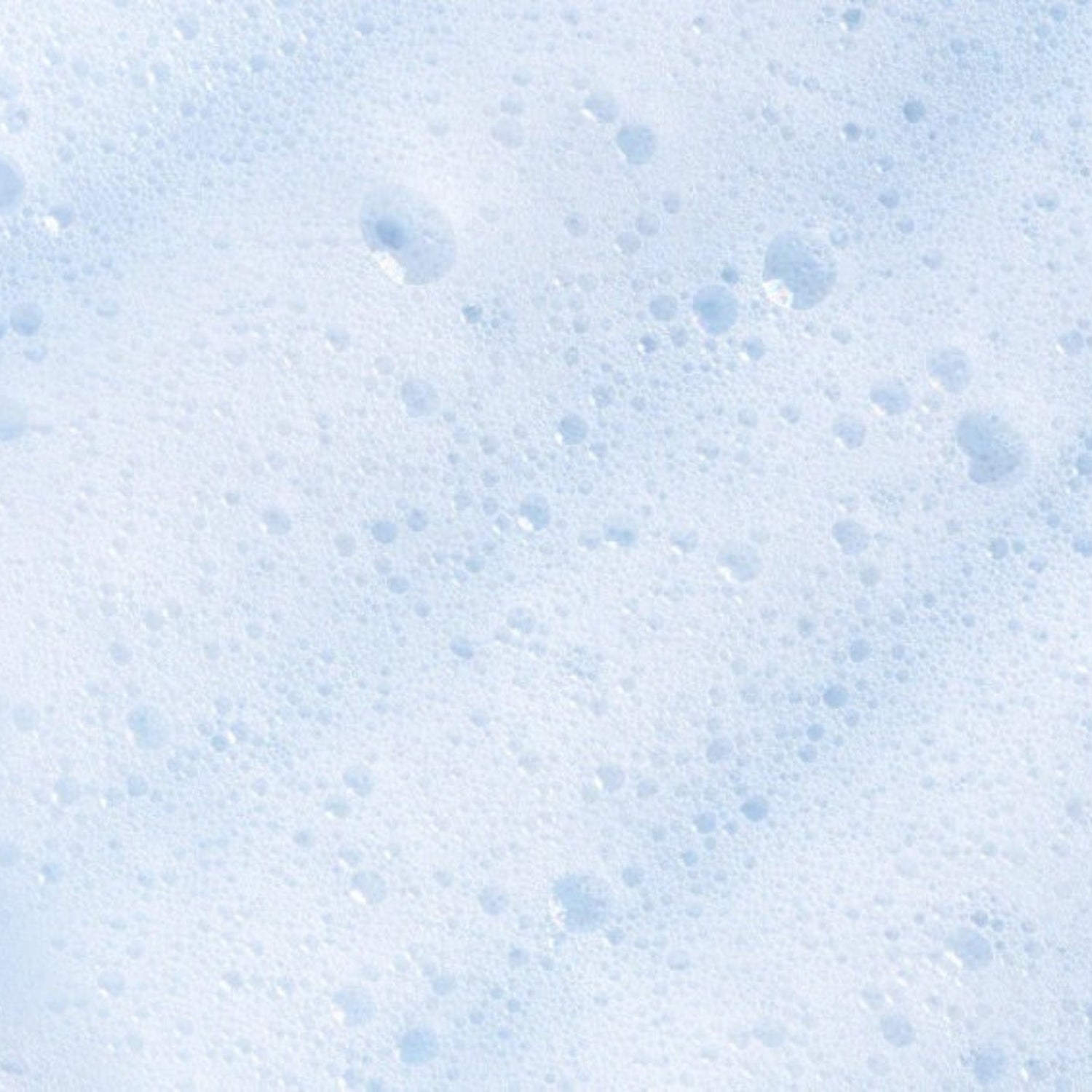 Close-up texture shot of airy, bubbly white foam, highlighting the lightweight consistency of the intimate cleanser.