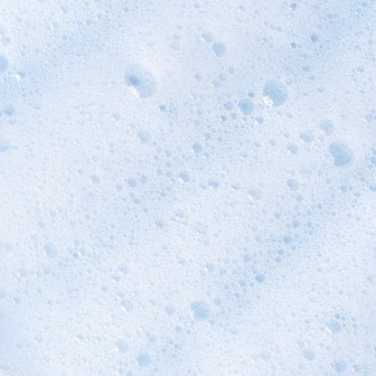 Close-up texture shot of airy, bubbly white foam, highlighting the lightweight consistency of the intimate cleanser.
