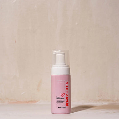 The 120 ml / 4 oz pink bottle of Beaver Butter Fresh Intimate Wash standing on a neutral, textured surface.