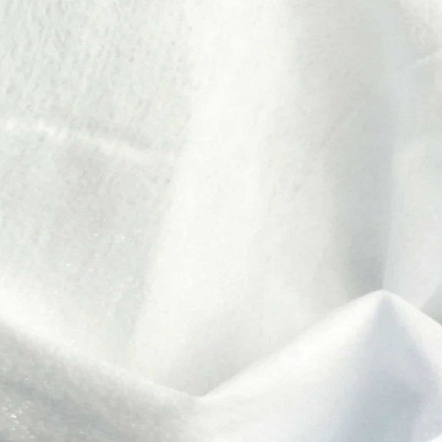 A detailed, close-up view of the clean, white, texturized fabric of a Beaver Butter intimate cleansing wipe, showcasing its soft, non-woven fibrous texture designed for gentle personal care.