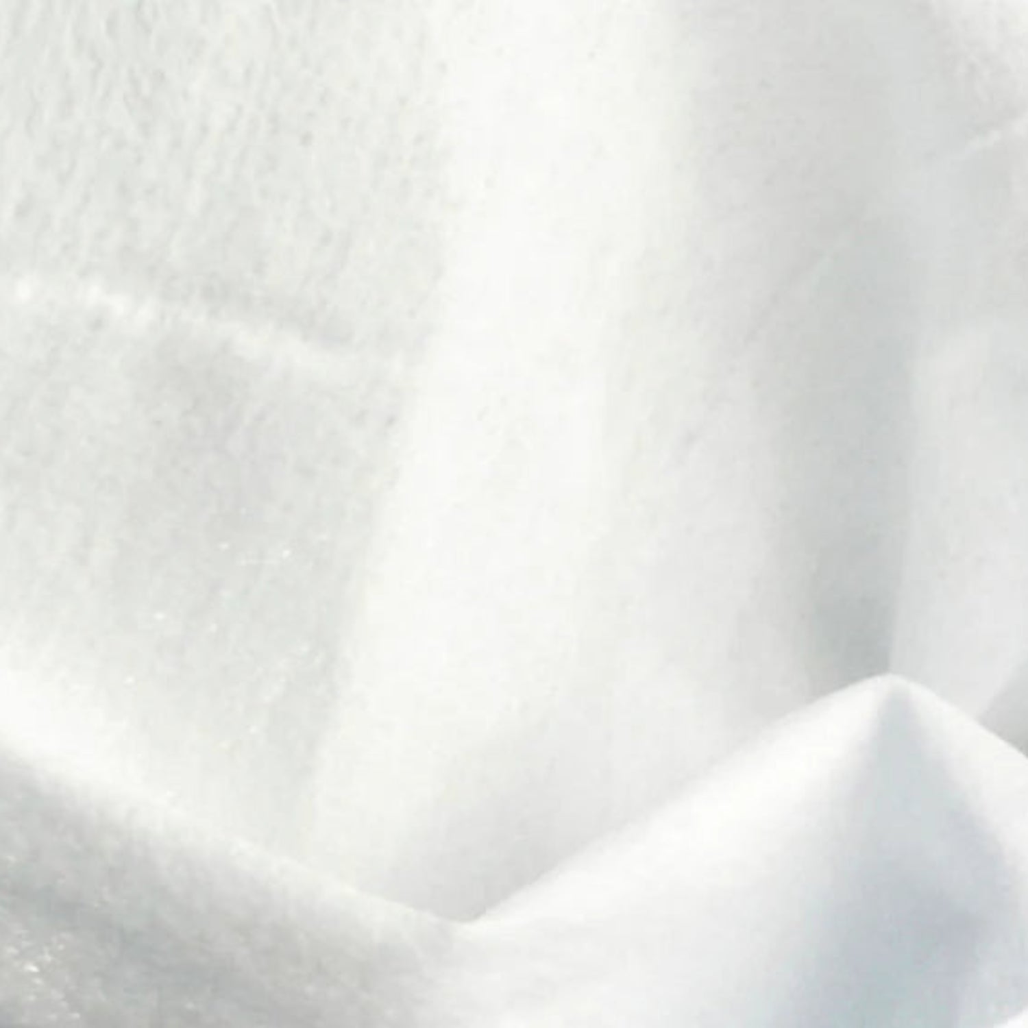 A detailed, close-up view of the clean, white, texturized fabric of a Beaver Butter intimate cleansing wipe, showcasing its soft, non-woven fibrous texture designed for gentle personal care.