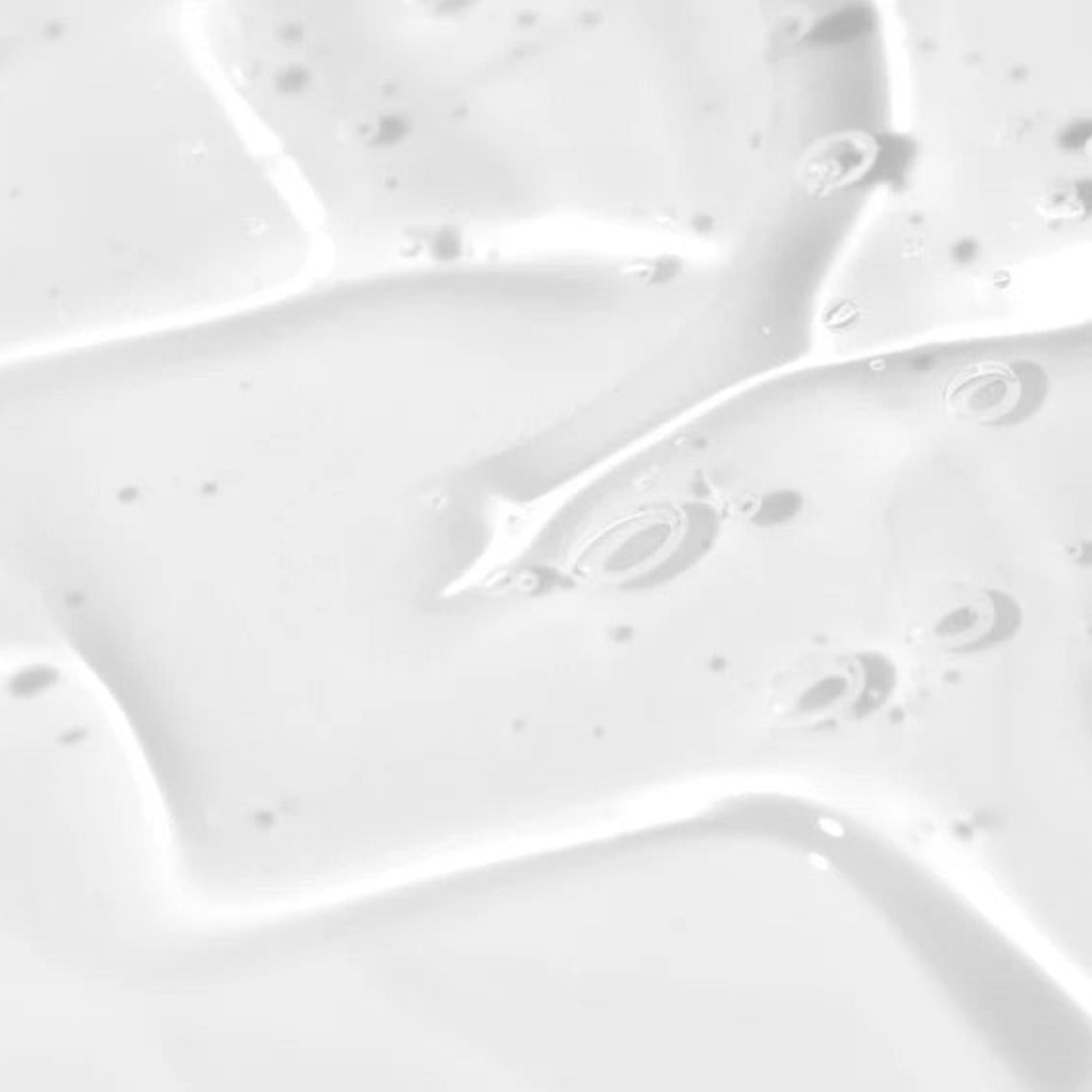 Close-up texture of a clear, watery, and lightweight ingrown hair serum showing air bubbles for a refreshing feel.