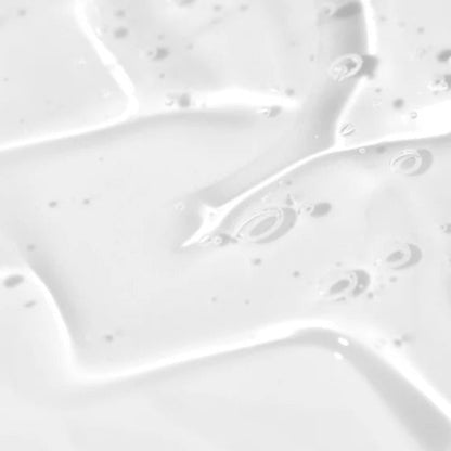 Close-up texture of a clear, watery, and lightweight ingrown hair serum showing air bubbles for a refreshing feel.