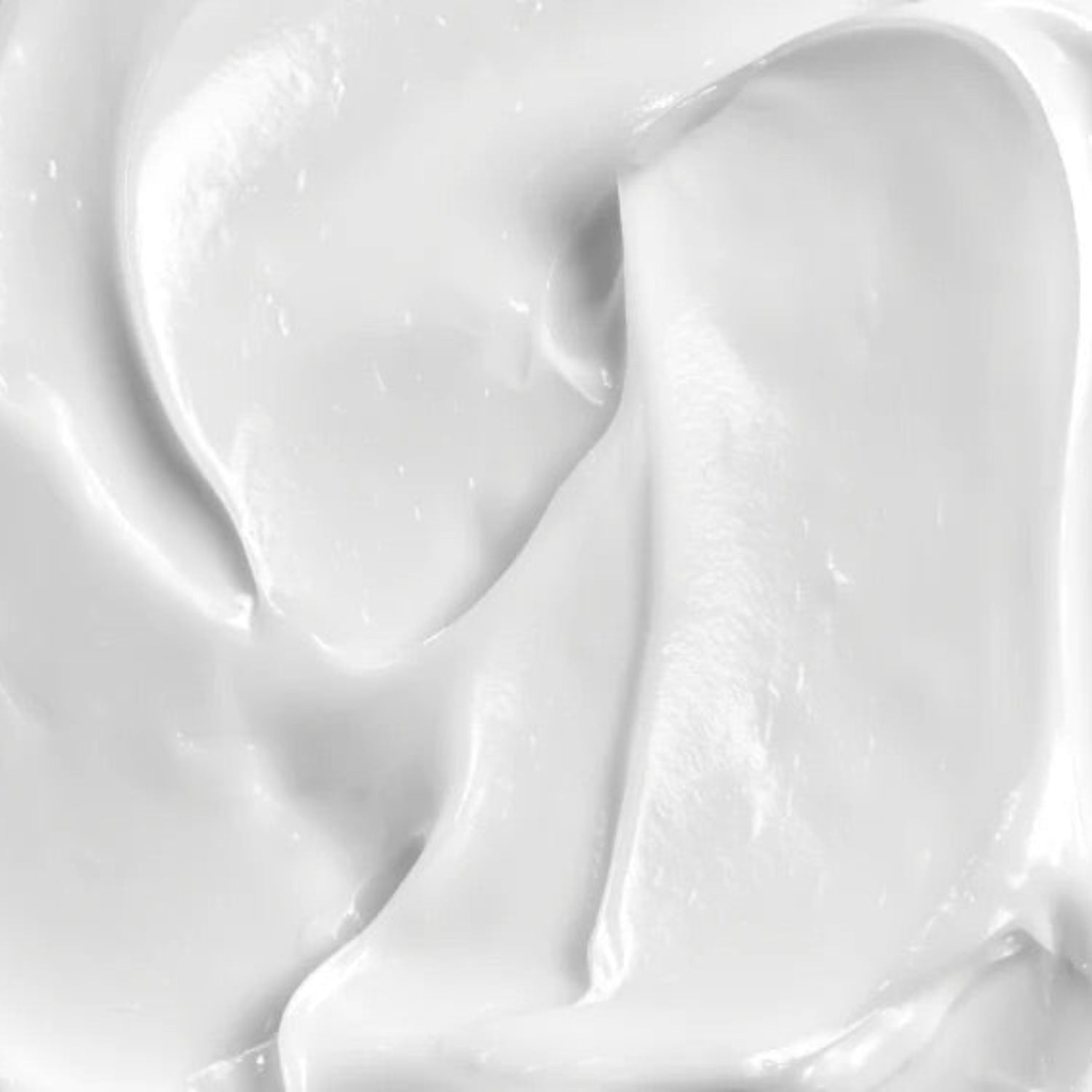 A high-resolution close-up of the thick, white Beaver Butter shaving cream texture, showing luxurious, silky swirls.