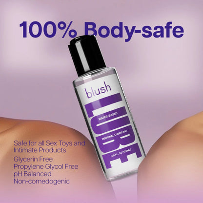 Promotional graphic for Blush water-based personal lubricant emphasizing it is 100% body-safe, safe for all sex toys, glycerin-free, propylene glycol-free, and non-comedogenic against a smooth skin backdrop.