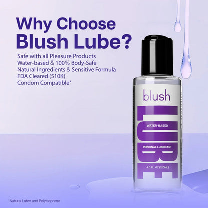A bottle of Blush water-based personal lubricant surrounded by clear liquid droplets, with text detailing its FDA-cleared status, natural ingredients, sensitive formula, and condom compatibility.