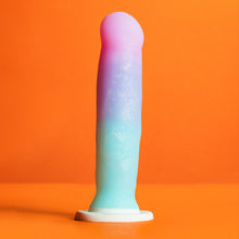 Load image into Gallery viewer, Bottom side of the blush Avant Lucky Dildo, placed on its suction cup with an orange background.
