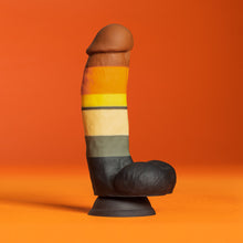 Load image into Gallery viewer, Side view of the blush Avant Pride Bear Realistic Dildo, placed on its suction cup, with an orange background.
