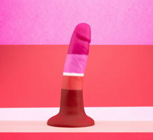 Load image into Gallery viewer, Side view of the blush Avant Pride Beauty Plugs, placed on its suction cup with a product themed colour scheme background.