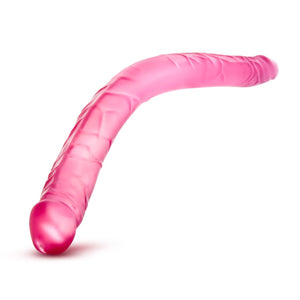  To Side view of the blush B Yours 16 Inch pink Double Dildo, bent in the middle, demonstrating its flexibility.