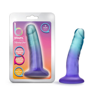 On the left side of the mage is the product packaging. On the product packaging is b yours brand logo, by blush logo,  product name: Morning dew, text bubbles: "Love my realistic feel"; "Try my suction cup. Its harness compatible!"; I'm body safe: Phthalate free (Pointing to the product); "5 inch dildo", and in the middle is a cutout display of the product inside. On the right is a bottom side view of the product blush B Yours Morning Dew 5 Inch Dildo, placed on its suction cup.