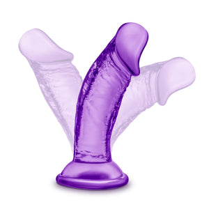 blush B Yours Sweet 'N Small 4 Inch Dildo placed on its suction cup, illustrating the flexibility of the product.