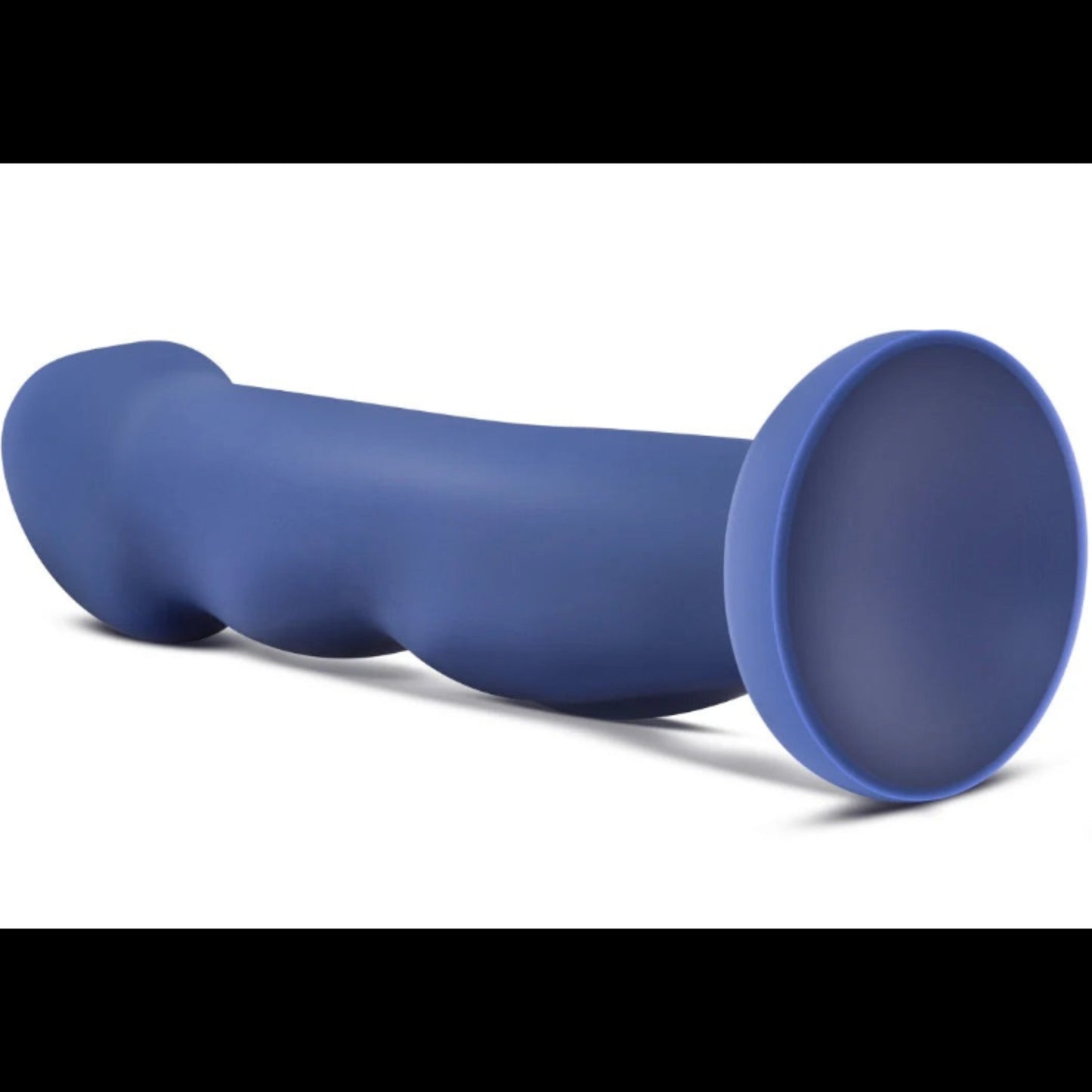 Side profile view of the blue Avant Suko Indigo D12 dildo lying flat, showing the flared suction cup base and curved ergonomic shaft.