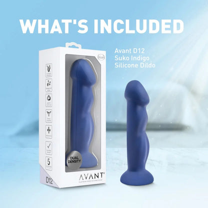 Avant Suko Indigo D12 silicone dildo standing on a white surface next to its packaging box under text reading "What's Included".