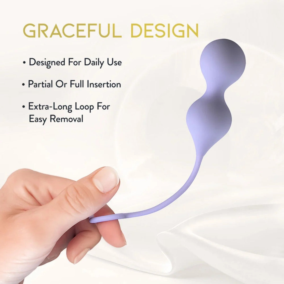 Hand holding the lavender Delice Chéri dual-weighted silicone Kegel trainer by its flexible retrieval loop, showcasing its ergonomic double-sphere contour.