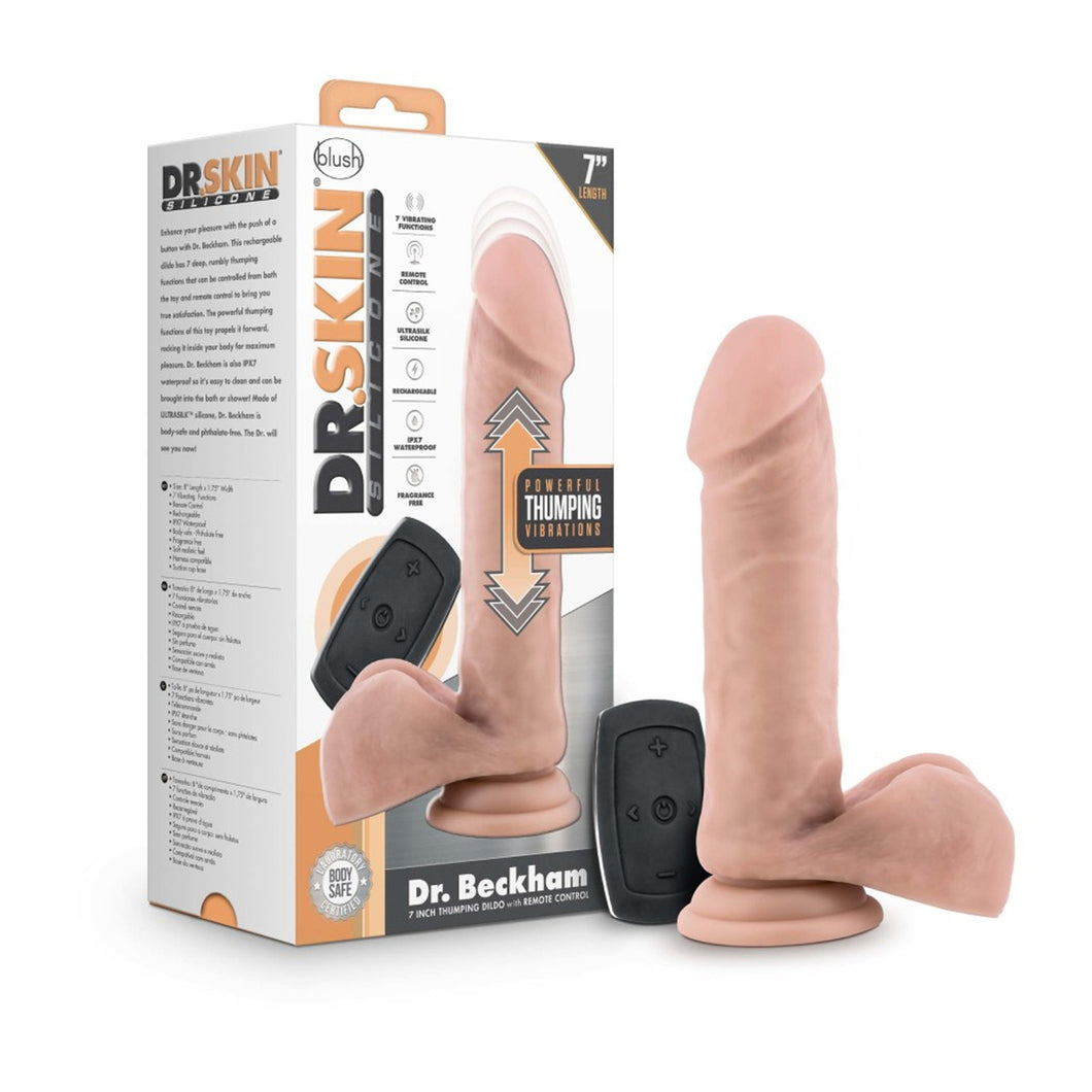 On the left side of the image is the product packaging. Beside the packaging is the product blush Dr. Skin Silicone Dr. Beckham 7 Inch Thumping Dildo, placed on its suction cup, and the wireless remote controller in between the product, and packaging.