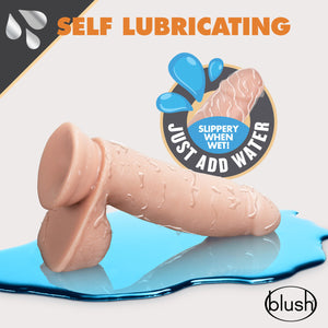 Top of the image has an icon for Self Lubricating, and below Just add Water - Slippery when wet. In the middle is the blush Dr. Skin Glide 7 Inch Lubricating Dildo With Balls, laying on a reflective smooth surface, that looks like a puddle of water, and with illustrated water marks all over the product. Bottom right is the blush logo.