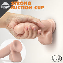 Load image into Gallery viewer, Top of the image has an icon for Strong suction cup, the image is showing blush Dr. Skin Glide 7 Inch Lubricating Dildo With Balls, being stuck on to a vertical smooth surface, with a female&#39;s hand gripping the product, demonstrating the strength of the suction cup. On the bottom left is an image of the back side of the product, and on the bottom right is the blush logo.