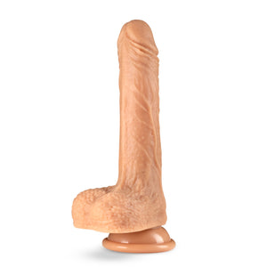 Side view of the blush Dr. Skin Silicone Dr Grey 7 Inch Thrusting, Gyrating Dildo, placed on its suction cup.