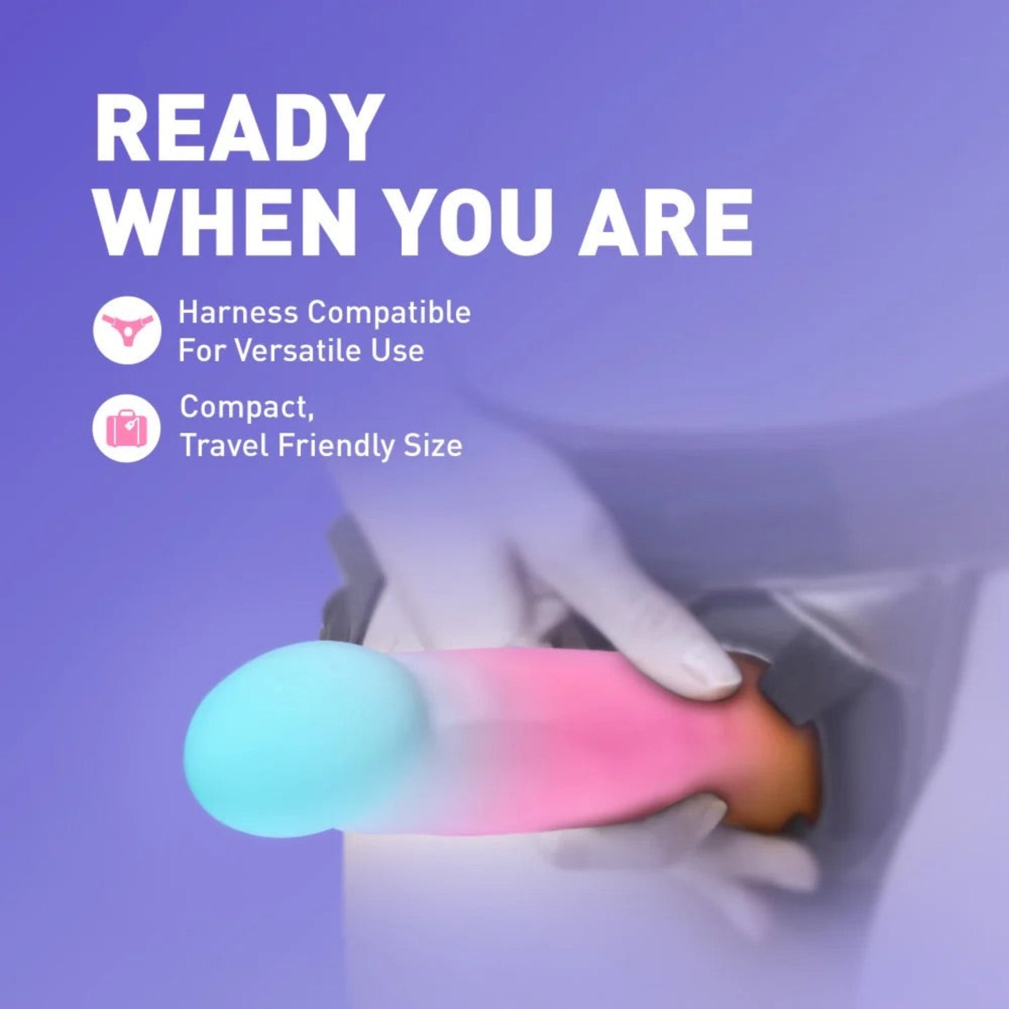 Hands securing the Avant Golden Dawn pastel liquid silicone dildo into a strap-on harness, highlighting universal O-ring harness compatibility for partnered play.