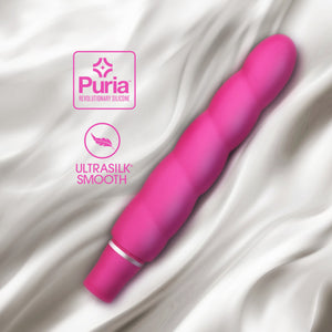 blush Luxe Anastasia Vibrator laying on a soft fabric, and icons for Puria revolutionary silicone & Ultrasilk smooth.