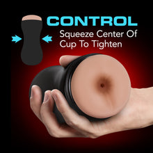 Charger l&#39;image dans la galerie, Illustrated image of the Stroker, with arrows pointing to each side of the centre of the stroker, with descriptive text &quot;Control, squeeze center of cup to tighten&quot;. In the middle of the image is a picture of a hand holding the stroker facing front.