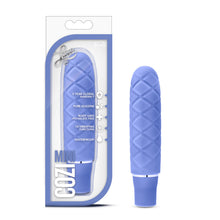 Load image into Gallery viewer, On the left side of the image is the Periwinkle variant product packaging. On the packaging is the Luxe logo, product feature icons for: 5 year global warranty; Pure silicone; Body safe phthalate free; 10 vibrating functions; waterproof, product name: Cozi mini, and the product inside fully visible through clear packaging. Beside the packaging, is the product blush Luxe Cozi Mini Periwinkle Vibrator, standing up on its base.