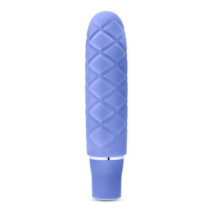 Side view of the blush Luxe Cozi Mini Periwinkle Vibrator, standing up on its base.