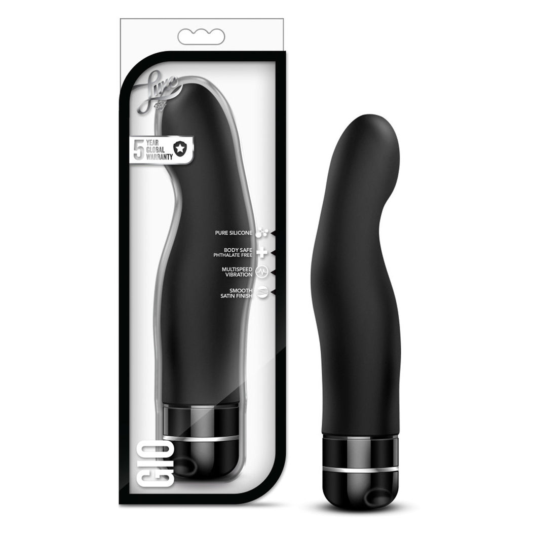 On the left side of the image is the product packaging. On the packaging is the Luxe logo, product feature icons for: 5 year global warranty; Pure silicone; Body safe phthalate free; Multispeed vibration; Smooth satin finish, in the bottom left is the product name: Gio, and the product inside fully visible through clear packaging. Beside the package is the product, blush Luxe Gio Vibrator standing on its base.