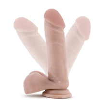 Load image into Gallery viewer, Side view of the blush Coverboy The Cowboy Realistic Dildo, placed on its suction cup, and visualization for the flexibility of the shaft.