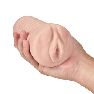 A hand is holding the blush M Elite Annabella Soft + Wet Stroker, facing front.