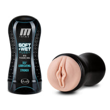 Load image into Gallery viewer, On the left side of the image is the product packaging for M For Men Soft + Wet Pussy With Pleasure Orbs Self lubricating Stroker by blush. Beside the Product packaging is the open stroker showing the insertion part of the product, laying flat on its side.