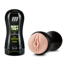 Load image into Gallery viewer, On the left side of the image is the product packaging for M For Men Soft + Wet Pussy With Pleasure Ridges Self lubricating Stroker by blush. Beside the Product packaging is the open stroker showing the insertion part of the product, laying flat on its side.