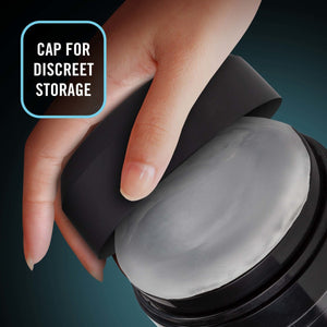 A female hand is holding the cap for the blush M For Men Torch Joyride Male Masturbator, partly showing inside, with caption: Cap for discreet storage.