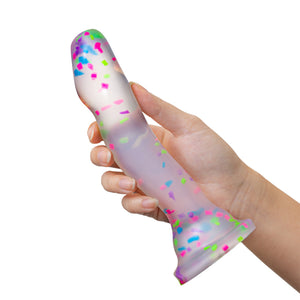 blush Neo Elite Hanky Panky 7.5 Inch Silicone Glow In The Dark Dildo being held in a hand, showing the size scale of the product.