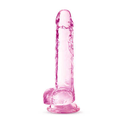 Bottom side view of the blush Naturally Yours 7 Inch Crystalline Dildo, standing on its suction cup base.