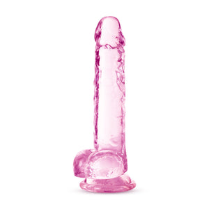 Bottom side view of the blush Naturally Yours 7 Inch Crystalline Dildo, standing on its suction cup base.