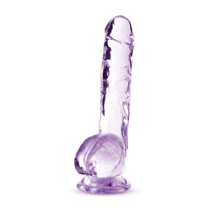 Bottom side view of the blush Naturally Yours 8 Inch Crystalline Dildo, placed on its suction cup base.