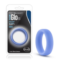 Load image into Gallery viewer, On the left side of the image is the product packaging. On the packaging is the Performance logo, product name: Silicone Glo Cock Ring, product features: Pure silicone; Flat design for a comfortable &amp; secure fit; strong &amp; stretchy, the product inside visible through clear packaging, &quot;1.5inch (38mm) diameter, and the blush logo in the bottom right. Beside the packaging is the product blush Performance Silicone Glo Blue Cock Ring.