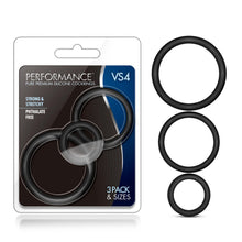 Load image into Gallery viewer, On the left side of the image is the product packaging. On the packaging is the Performance logo, product name: VS4 Pure Premium Silicone Cock Rings, product features: Strong &amp; stretchy; phthalate free, in the middle is the product visible through clear packaging, and on the bottom right corner is written: 3 Pack &amp; sizes. Beside the packaging are the 3 Cock Rings vertically placed from Large to small.