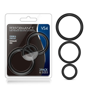 On the left side of the image is the product packaging. On the packaging is the Performance logo, product name: VS4 Pure Premium Silicone Cock Rings, product features: Strong & stretchy; phthalate free, in the middle is the product visible through clear packaging, and on the bottom right corner is written: 3 Pack & sizes. Beside the packaging are the 3 Cock Rings vertically placed from Large to small.