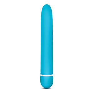 Side view of the blush Rose Luxuriate blue Vibrator, standing on the bottom of it's battery cap.