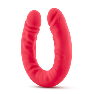 Bottom side view of the blush Ruse Silicone Thick Double Headed Dildio, while standing on the centre of its U-Shape.