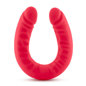Side view of the blush Ruse Silicone Thick Double Headed Dildio, while standing on the centre of its U-Shape.