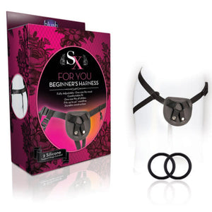 Left side of image is product packaging. On left side of packaging a backside view of harness on mannequin. On front side of packaging SX For You logo, product name: Begenierrs harrness, product features: Fully adjustable - One size fits most; comfortable fit; Fits up to a 42" waist; Durablle construction, an image of harness facing front, and in bottom left corner "2 Silicone Support rings included". Beside packaging is the harness on a mannequin facing front, and 2 silicone rings below.