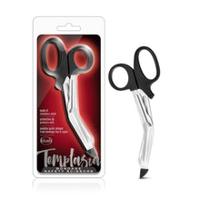 Load image into Gallery viewer, On the left side of the image is the product packaging. On the packaging is the product visible through clear packaging, product features: made of stainless steel; Protective tip protects skin; Enables quick release from bondage ties &amp; ropes, blush &amp; Temptasia logos below, product name: Bondage Safety Scissors. Beside the packaging is the product standing on its tip.