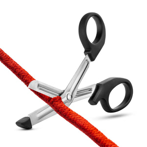 Front side view of the blush Temptasia Bondage Safety Scissors cutting through a rope.