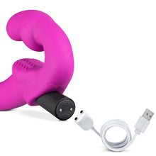 Load image into Gallery viewer, Close up of the blush Temptasia Estella Strapless Dildo&#39;s bullet vibe with the charging cable showing where, and how to charge the bullet vibe.