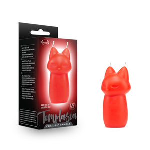 On the left side of the image is the product packaging. On the packaging are the blush & Temptasia logos, an image of the product  across the packaging, on the bottom are product features: Warm wax for sensation play; 3.75" length, and the product name: Fox drip candle. Beside the packaging is the product.